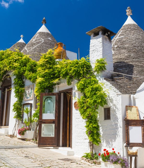 Beautiful,Town,Of,Alberobello,With,Trulli,Houses,Among,Green,Plants